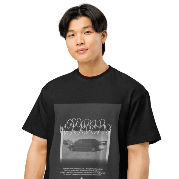 Front-facing view of a black men’s box-fit t-shirt with a structured silhouette and classic crew neckline. Displayed against a neutral background, the shirt’s deep tone and clean lines reflect the bold, minimalist aesthetic of the “Good Kid Maad City” collection—channeling lyrical grit and urban fashion into a sleek, wearable statement.