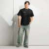 Front-facing view of a men’s box-fit t-shirt in solid black, featuring a structured silhouette, relaxed sleeves, and classic crew neckline. Set against a neutral background, the shirt’s deep tone and clean lines reflect Rap Stitches’ music-inspired streetwear—fusing everyday comfort with bold, minimalist style