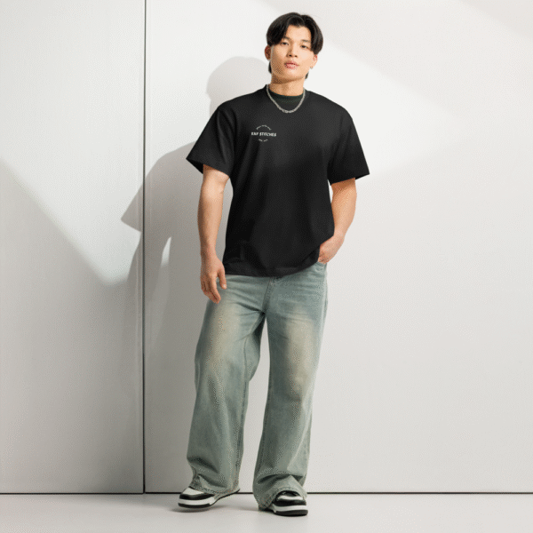Front-facing view of a men’s box-fit t-shirt in solid black, featuring a structured silhouette, relaxed sleeves, and classic crew neckline. Set against a neutral background, the shirt’s deep tone and clean lines reflect Rap Stitches’ music-inspired streetwear—fusing everyday comfort with bold, minimalist style