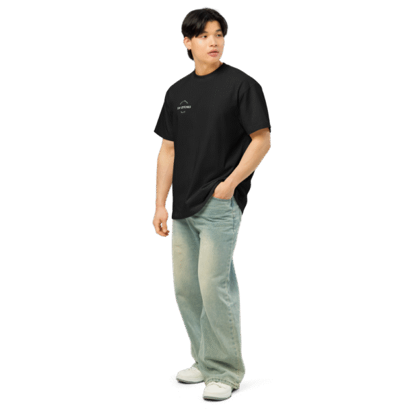 Left-front angled view of a men’s box-fit t-shirt in solid black, featuring a structured silhouette, relaxed sleeves, and classic crew neckline. Set against a neutral background, the shirt’s deep tone and clean lines reflect Rap Stitches’ music-inspired streetwear—fusing everyday comfort with bold, minimalist style.