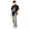 Left-front angled view of a black men’s box-fit t-shirt with a structured silhouette and classic crew neckline. Displayed against a neutral background, the shirt’s deep tone and clean lines reflect the bold, minimalist aesthetic of the “Good Kid Maad City” collection—channeling lyrical grit and urban fashion into a confident, wearable statement.