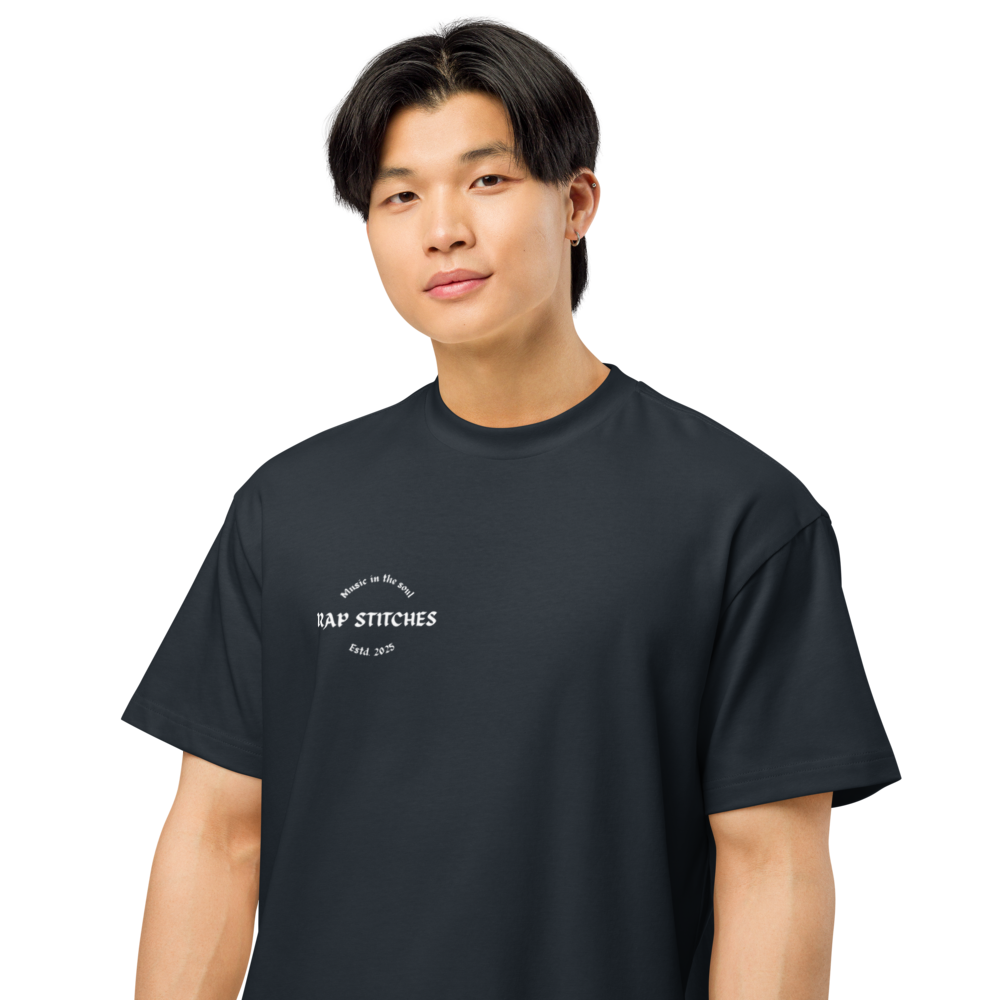 Portrait view of a person wearing a men’s box-fit t-shirt in navy blue, featuring a structured silhouette, relaxed sleeves, and classic crew neckline. Set against a neutral background, the shirt’s deep tone and clean lines reflect Rap Stitches’ music-inspired streetwear—merging everyday comfort with bold, minimalist style.