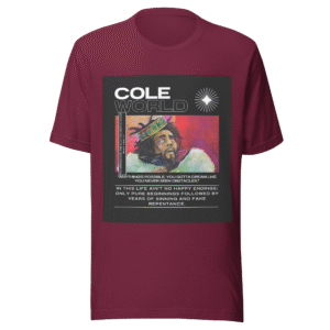 Front-facing view of a maroon unisex staple t-shirt with a relaxed fit and classic crew neckline. Set against a neutral background, the shirt’s smooth texture and deep color reflect the minimalist, introspective tone of the Cole World designer series—blending lyrical storytelling with everyday streetwear appeal