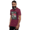 Left-front angled view of a maroon unisex staple t-shirt with a soft, structured fit and classic crew neckline. Set against a neutral backdrop, the shirt’s clean lines and deep color reflect the understated confidence and lyrical edge of the Cole World designer series.
