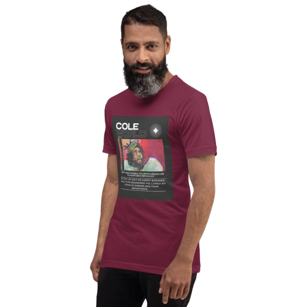 Left-front angled view of a maroon unisex staple t-shirt with a soft, structured fit and classic crew neckline. Set against a neutral backdrop, the shirt’s clean lines and deep color reflect the understated confidence and lyrical edge of the Cole World designer series.