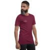 Right-front angled view of a unisex maroon staple t-shirt with a structured silhouette and classic crew neckline. Displayed against a neutral background, the shirt’s rich color and minimalist design reflect Rap Stitches’ music-inspired streetwear—blending everyday comfort with bold, understated style.