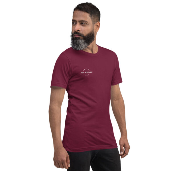 Right-front angled view of a unisex maroon staple t-shirt with a structured silhouette and classic crew neckline. Displayed against a neutral background, the shirt’s rich color and minimalist design reflect Rap Stitches’ music-inspired streetwear—blending everyday comfort with bold, understated style.
