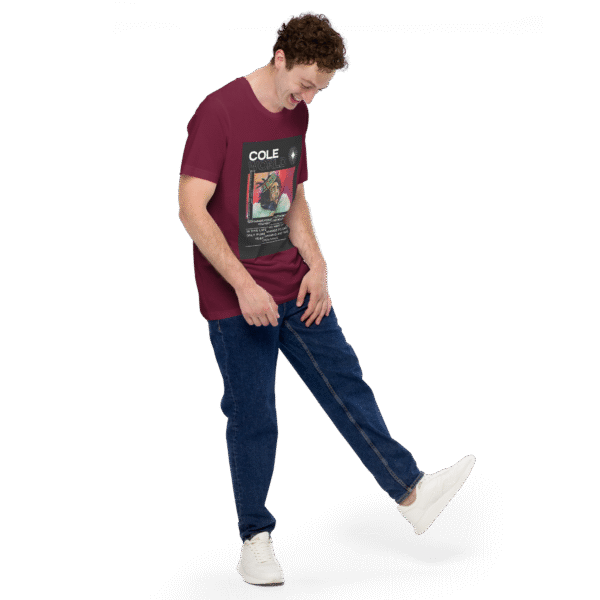 Front-right view of a maroon unisex staple t-shirt displayed against a plain background. The shirt features a clean, minimalist cut with short sleeves and a crew neckline, emphasizing its casual and versatile design.