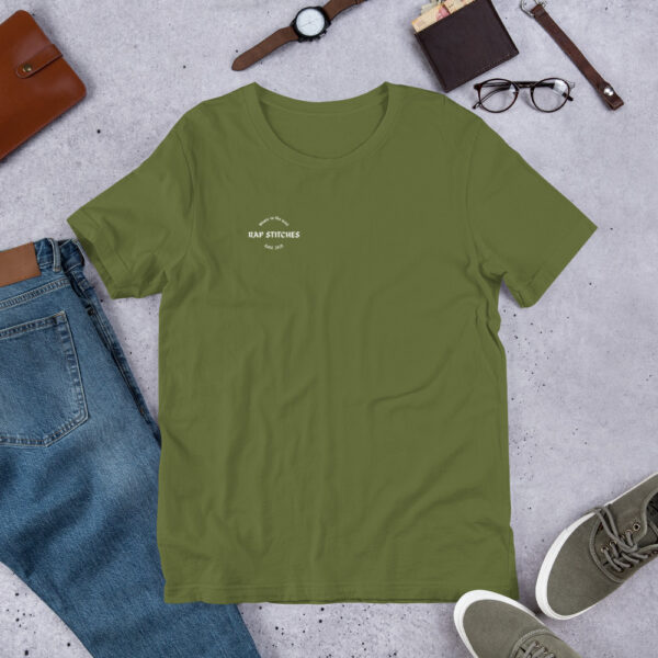 Front-facing view of a unisex olive green staple t-shirt with a structured silhouette and classic crew neckline. Displayed against a neutral background, the shirt’s earthy tone and minimalist design reflect Rap Stitches’ music-inspired streetwear—blending everyday comfort with bold, understated style.